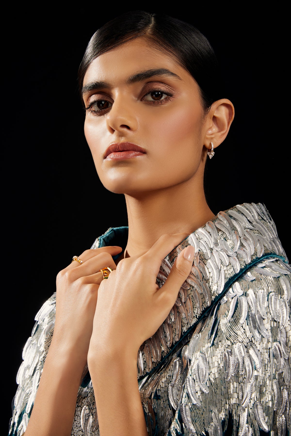 The Silver Feather Cape in petrol silk velvet with silver beaded feathers, close-up, dark studio