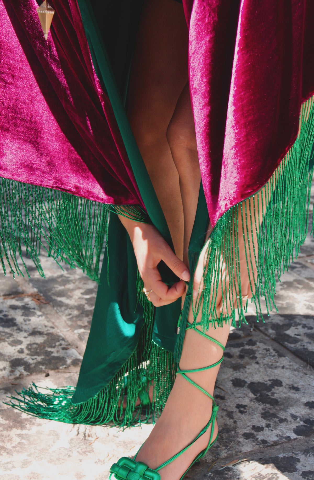 The Dahlia Sparkle Poncho in magenta silk velvet with emerald beaded fringe, fringe detail