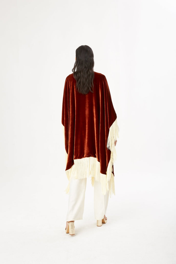 The Bronze Poncho in bronze silk velvet with cream fringe, back view, studio