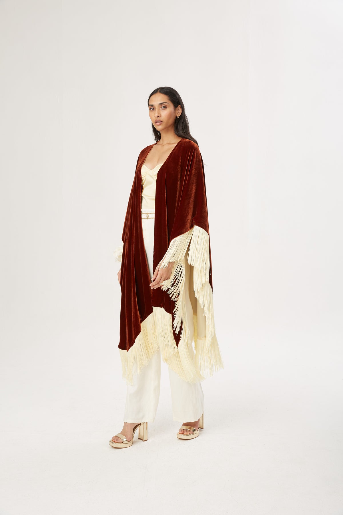 The Bronze Poncho in bronze silk velvet with cream fringe, full length, studio