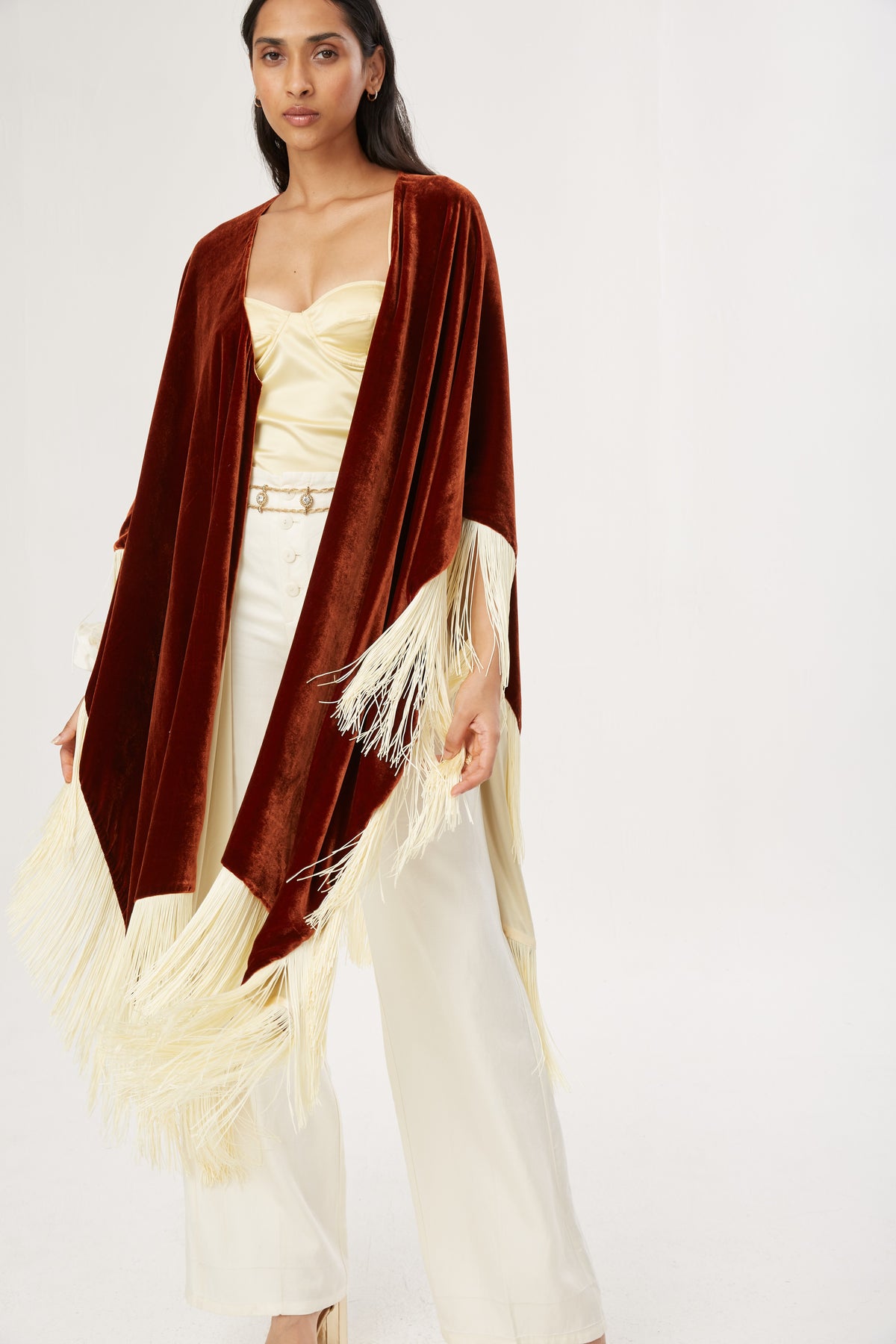 The Bronze Poncho in bronze silk velvet with cream fringe, studio