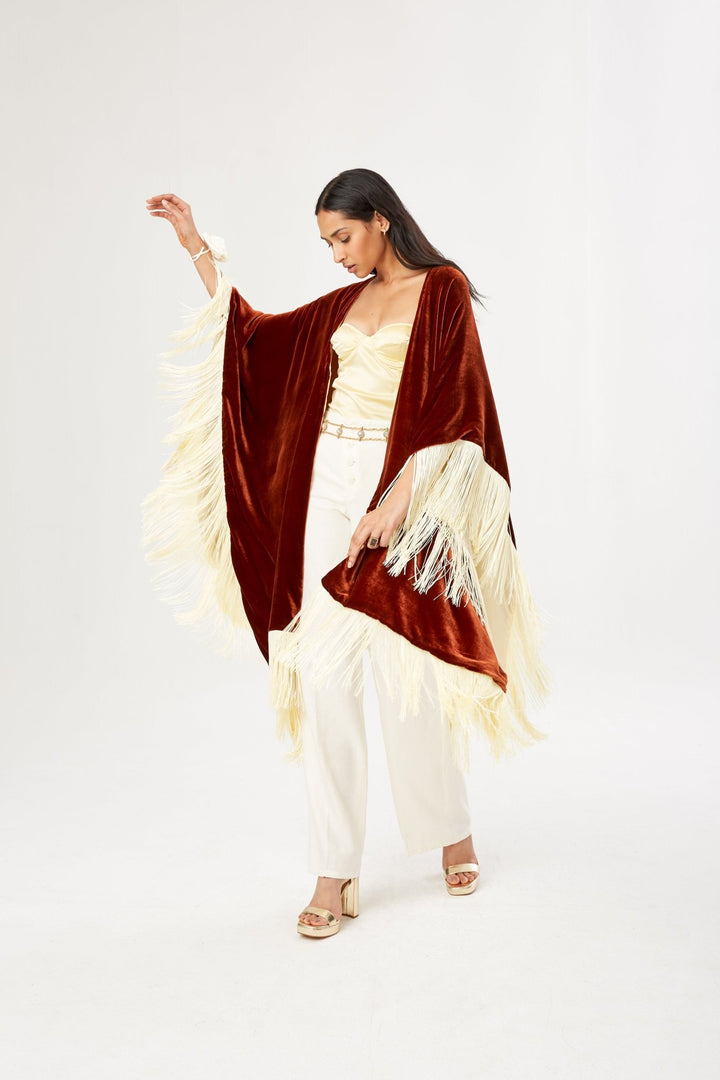The Bronze Poncho in bronze silk velvet with cream fringe, in motion, studio