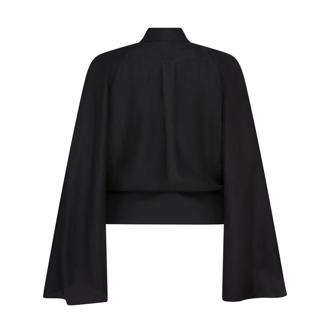 The Cape Sleeve Blouse in black silk twill, flat lay back, studio