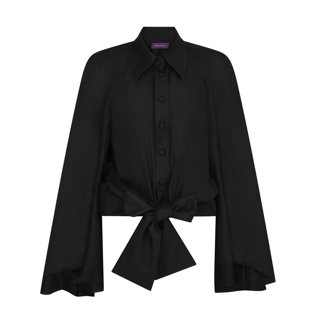 The Cape Sleeve Blouse in black silk twill, flat lay front with bow, studio