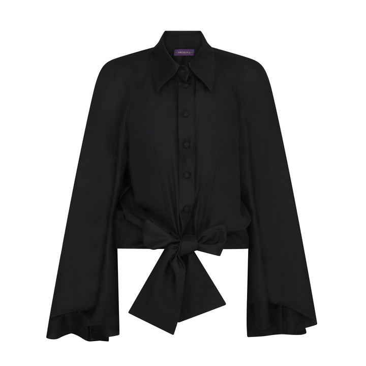 The Cape Sleeve Blouse in black silk twill, flat lay front with bow, studio