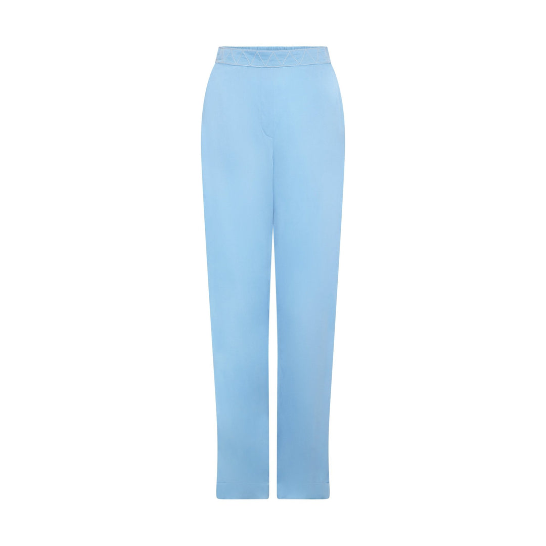 The Cornflower Trousers in powder blue silk, flat lay, studio