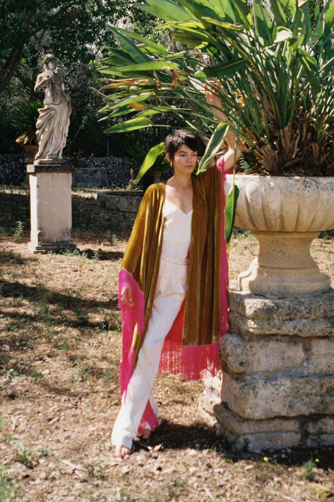 The Cream White Camisole in cream silk, styled with the Limoncello Poncho, garden
