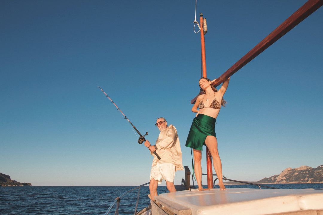 The Emerald Wrap Skirt in emerald green silk, on a boat at sea