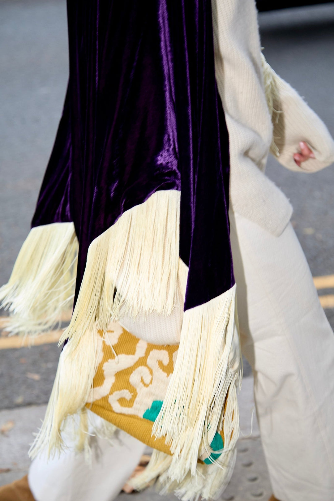 The Gatsby Poncho in purple silk velvet with champagne fringe, fringe detail, London street
