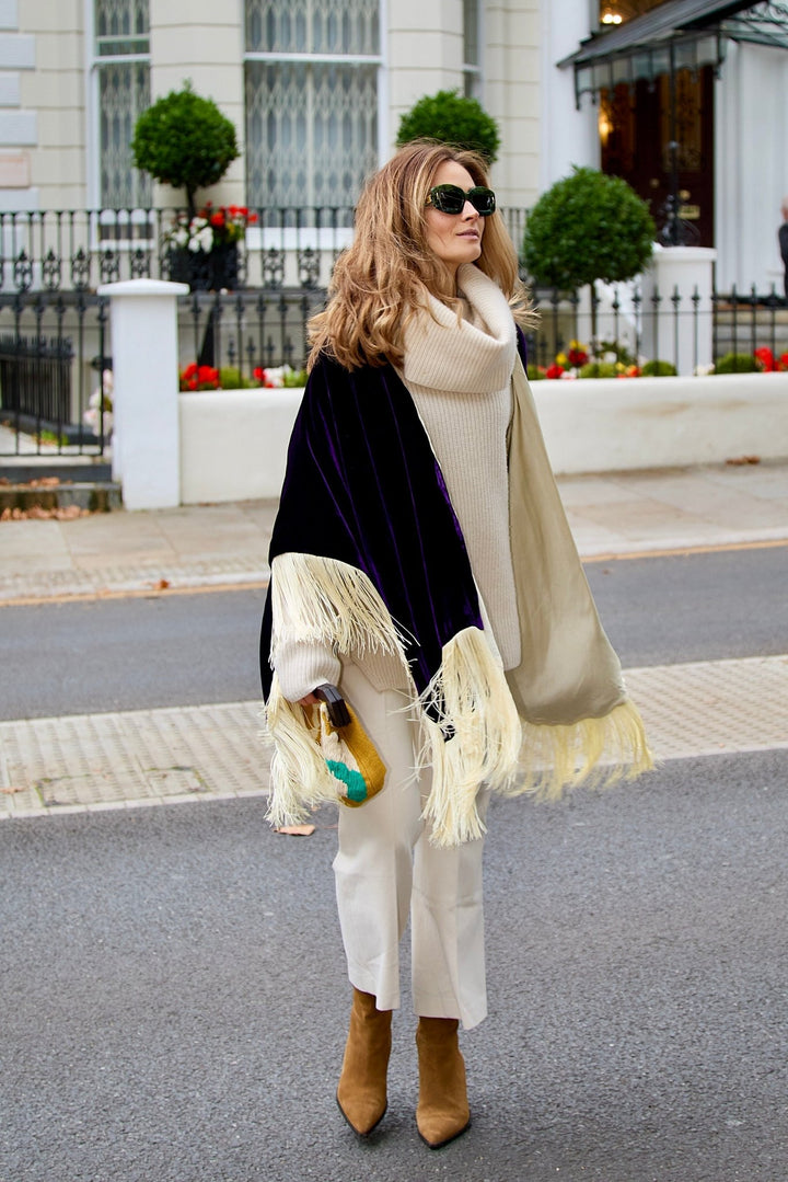 The Gatsby Poncho in purple silk velvet with champagne fringe, front view, London street