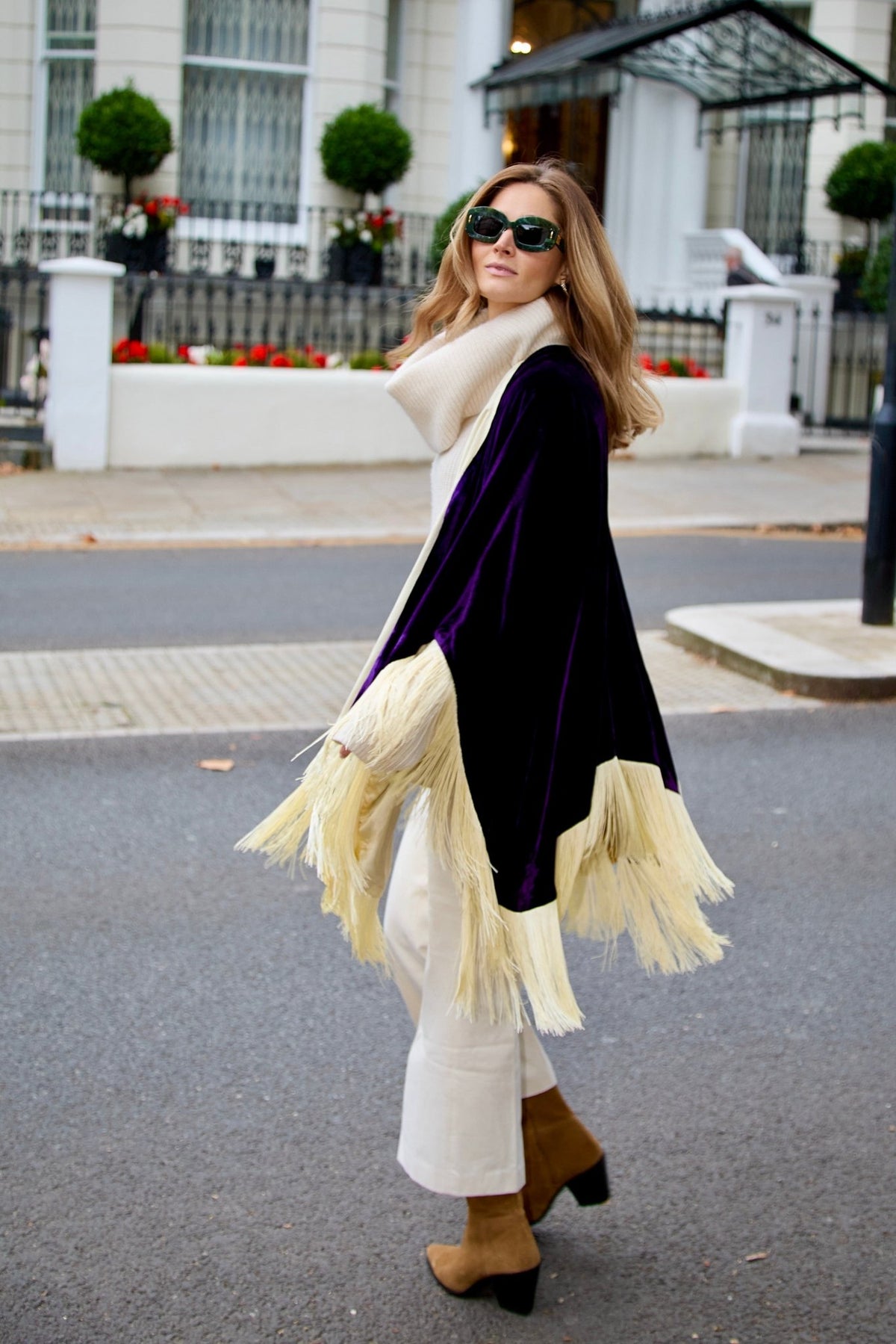 The Gatsby Poncho in purple silk velvet with champagne fringe, side view, London street