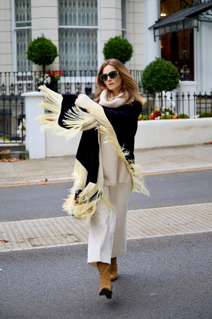 The Gatsby Poncho in purple silk velvet with champagne fringe, walking, London street