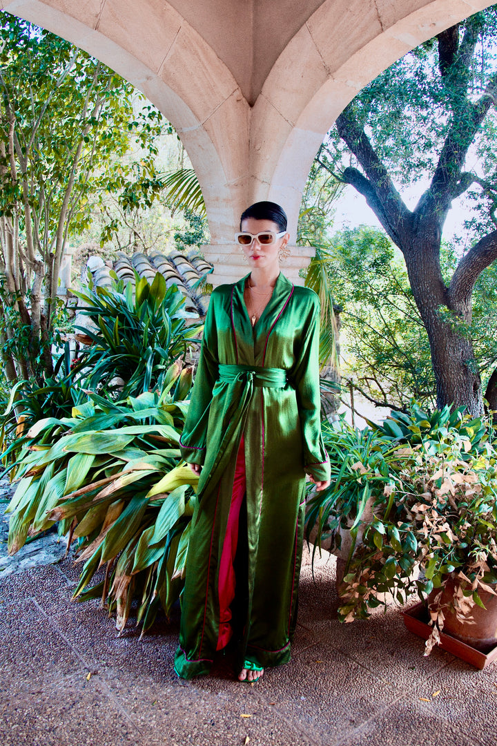 The Jade Vine Kimono in emerald green heavy silk, front view, garden archway