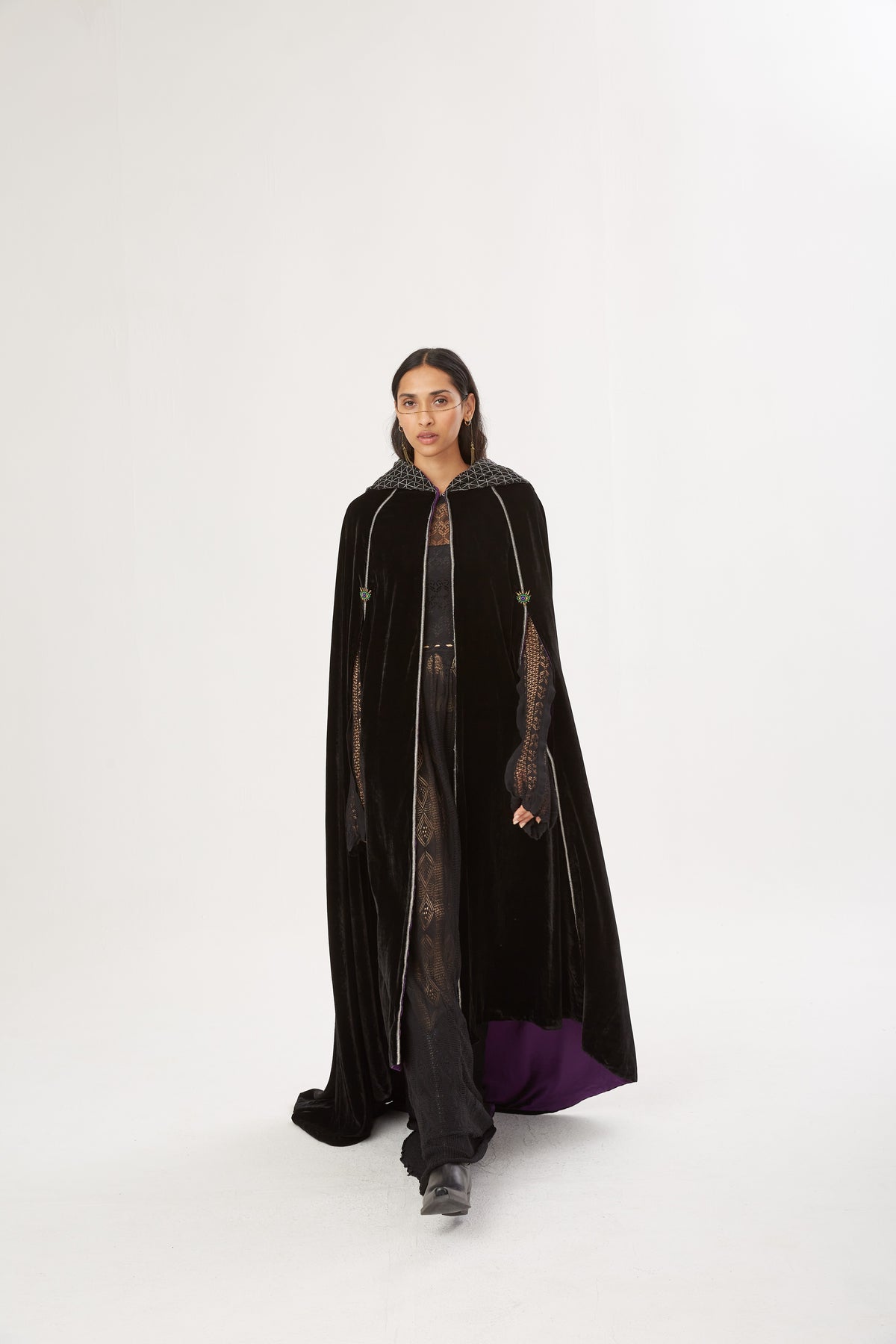 The Mystery Cape in black silk velvet with purple lining and embroidered hood, full length, studio