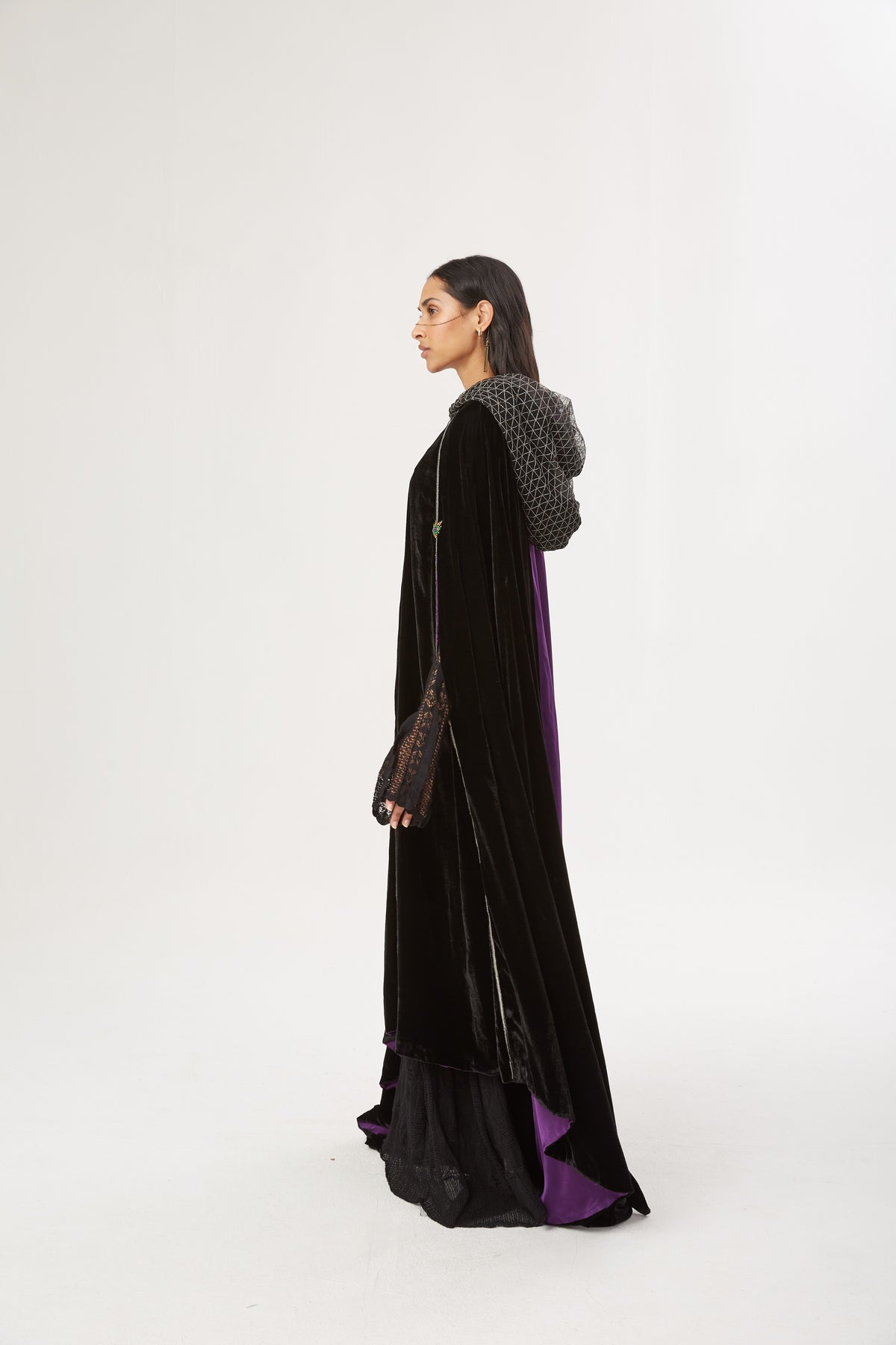 The Mystery Cape in black silk velvet with purple lining and embroidered hood, side view, studio