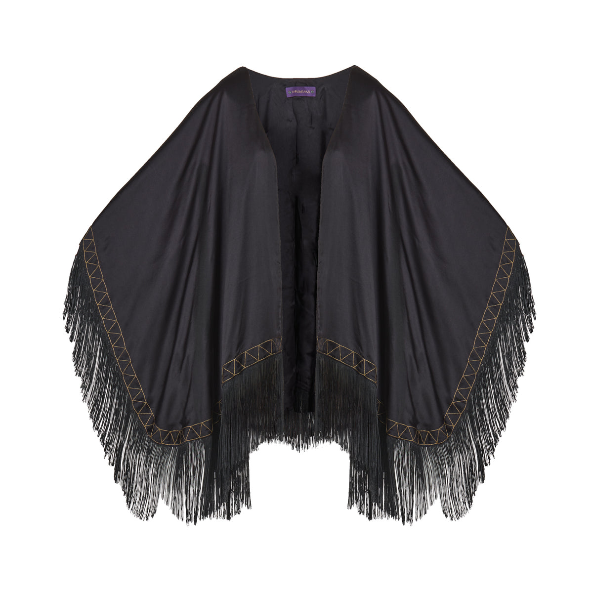 The Nomad Poncho in black silk with gold hand embroidery and black fringe, flat lay, studio
