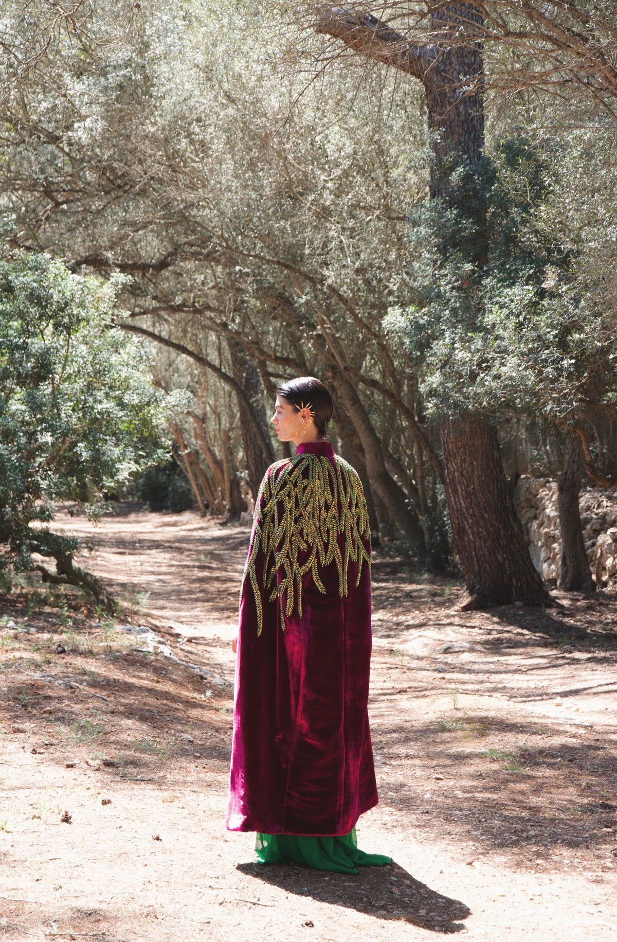 The Royal Garden Cape in magenta silk velvet with gold and green leaf embroidery, back view, olive grove