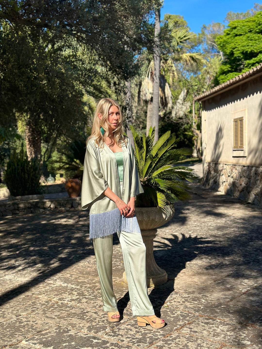 The Sage Bandeau Top in sage silk, styled with the Sage Leaf Kimono, garden