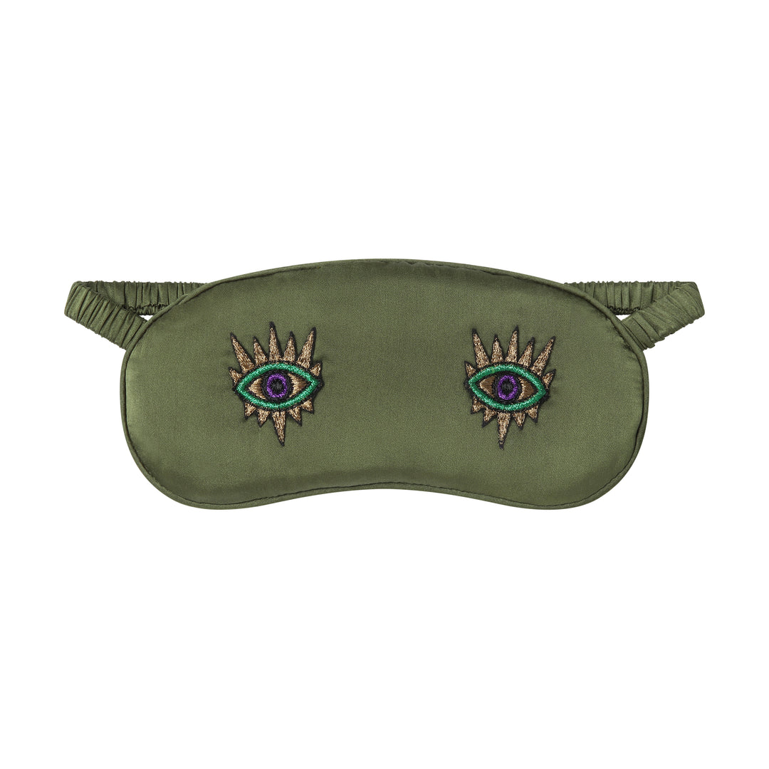 The Silk Sleeping Mask "Eyes Wide Open" in olive green silk with embroidered eyes, front, studio
