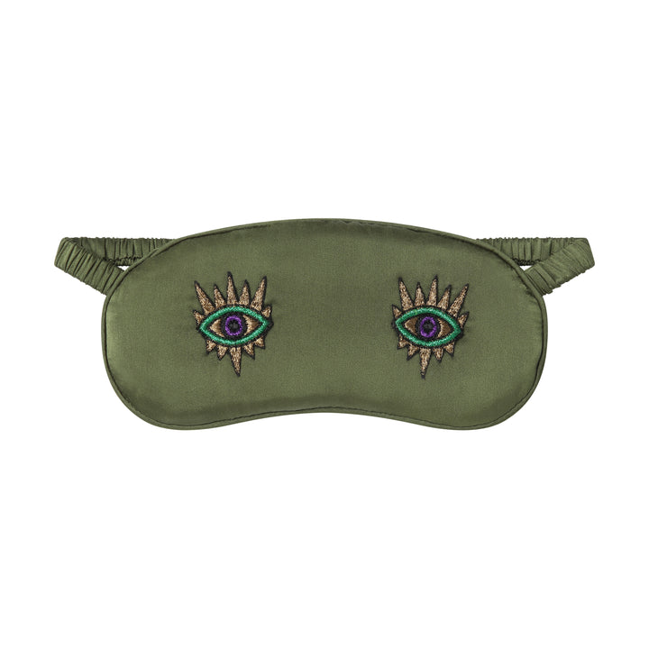 The Silk Sleeping Mask "Eyes Wide Open" in olive green silk with embroidered eyes, front, studio