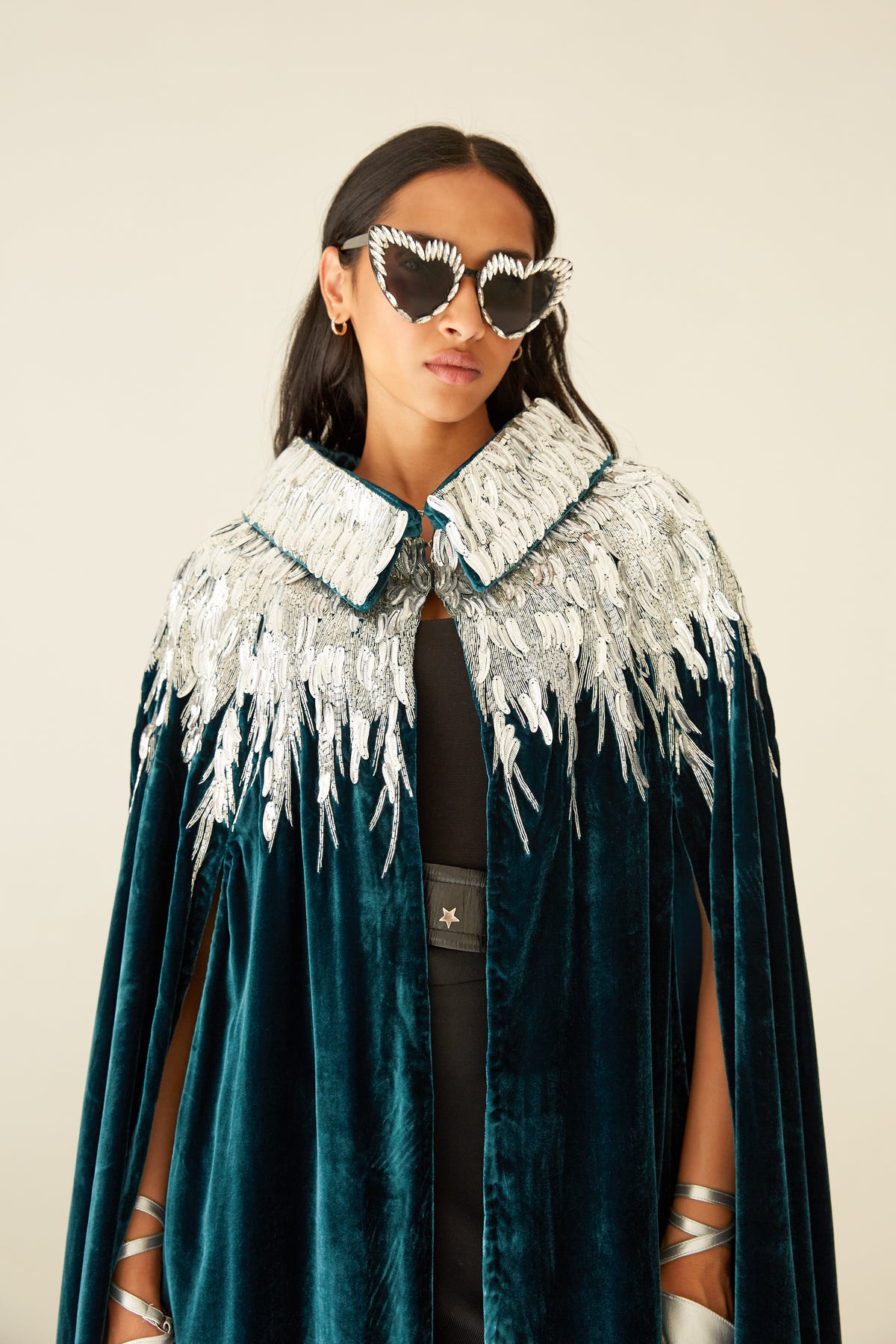 The Silver Feather Cape in petrol silk velvet with silver beaded feathers, close-up, studio