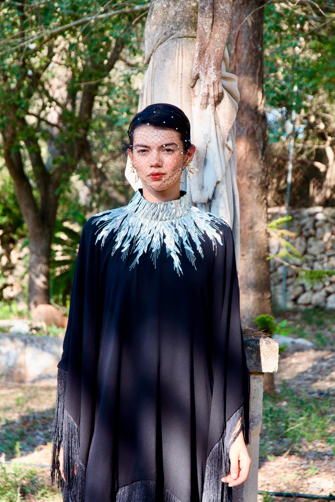 The Silver Feather Dress in black silk georgette with silver feather embroidery, front view, woodland