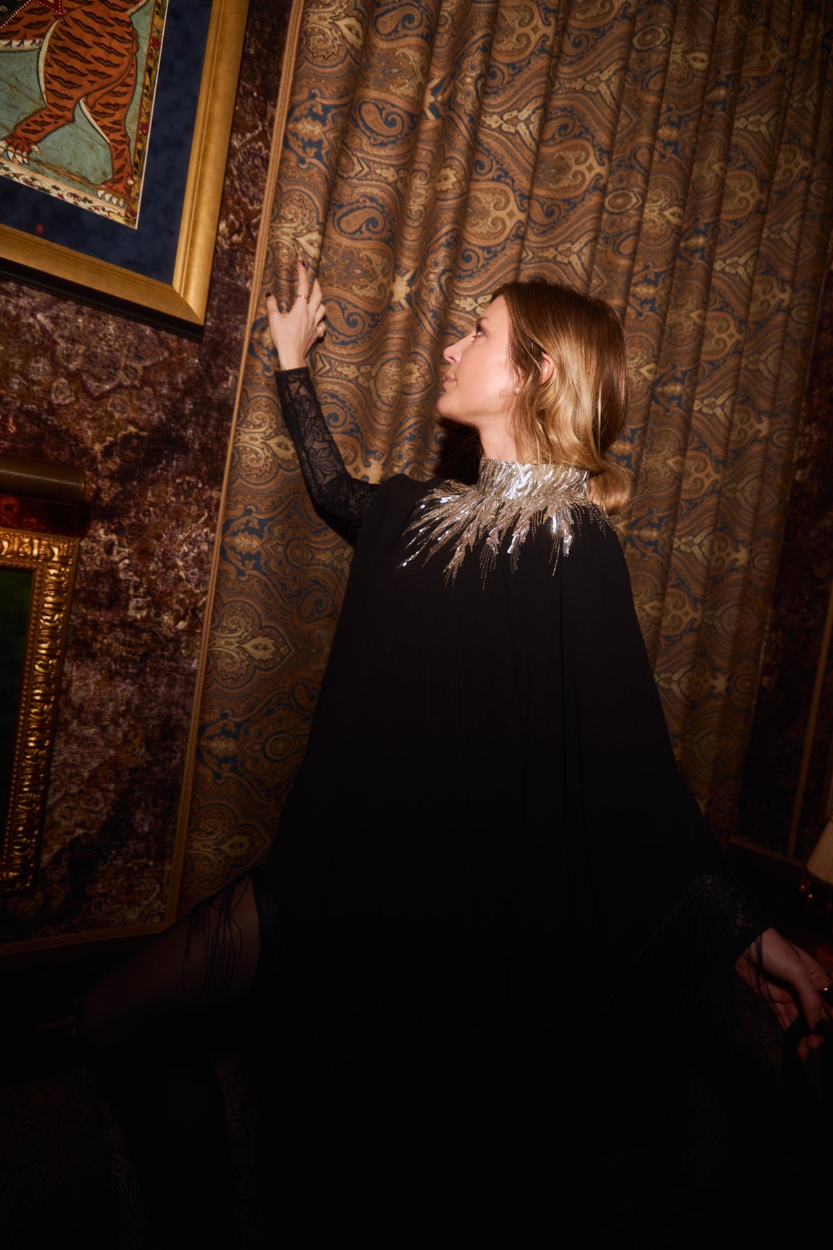 The Silver Feather Dress in black with a silver feather collar, worn, interior