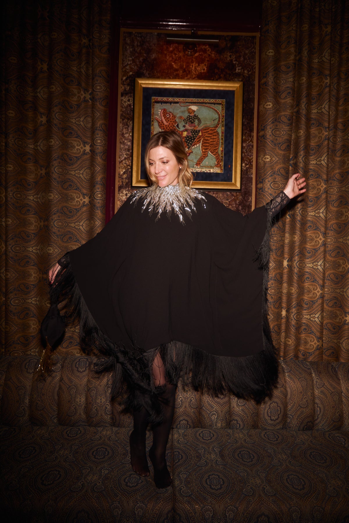 The Silver Feather Dress in black with a silver feather collar, worn, interior