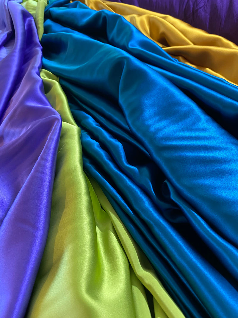 Mulberry silk satins in violet, petrol, lime and gold, draped together in the atelier