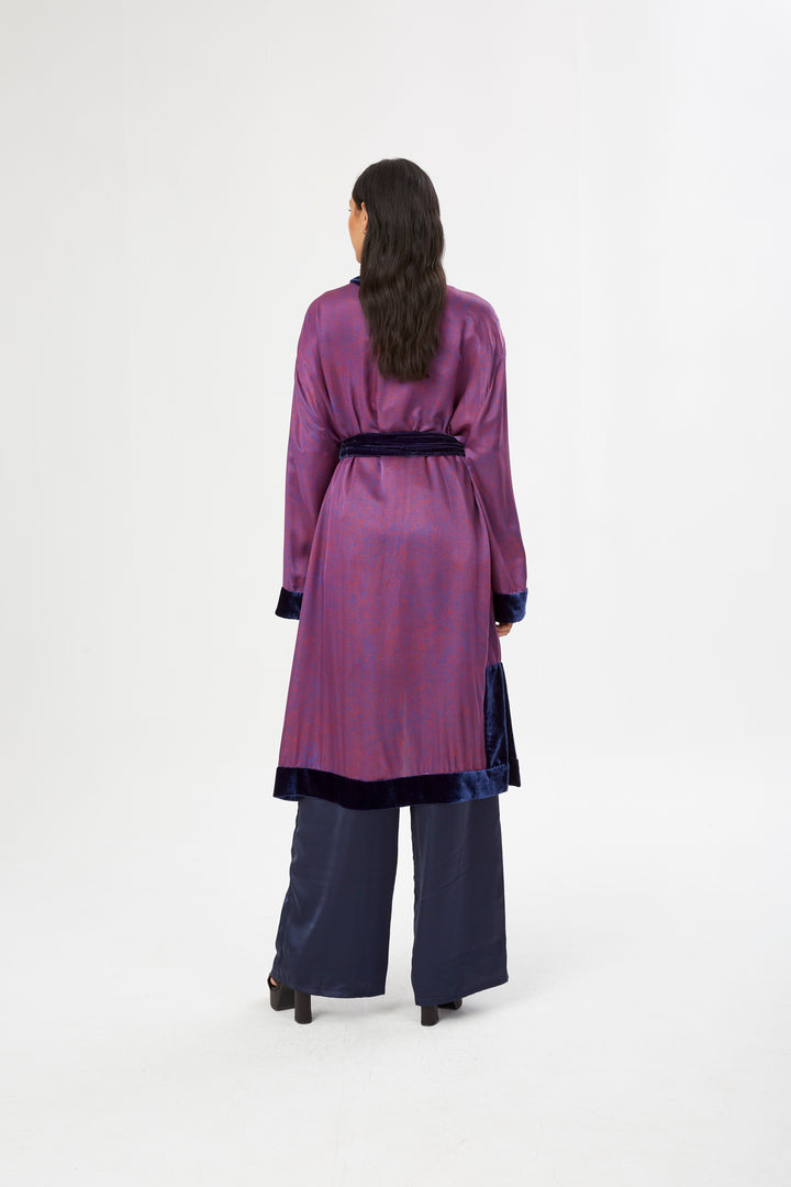 The Mazestroom Kimono, Navy and Red, in red and navy maze-print silk with velvet trim, back view, studio