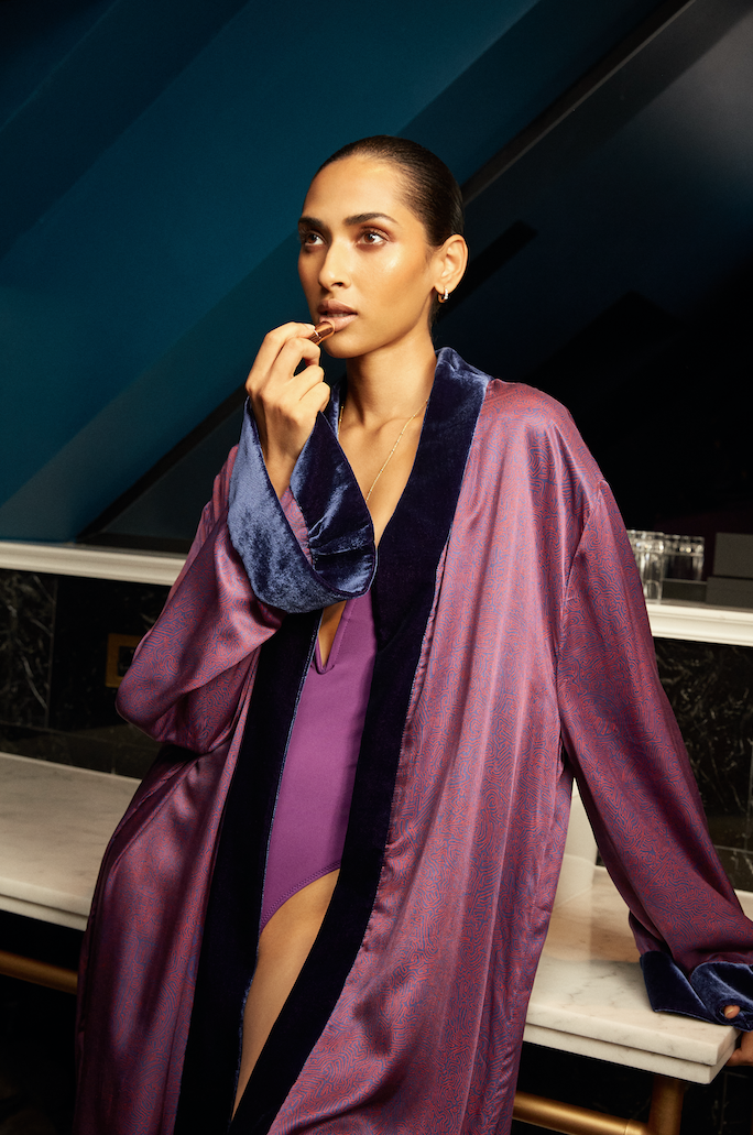 The Mazestroom Kimono, Navy and Red, in red and navy maze-print silk with velvet trim, close-up, evening interior