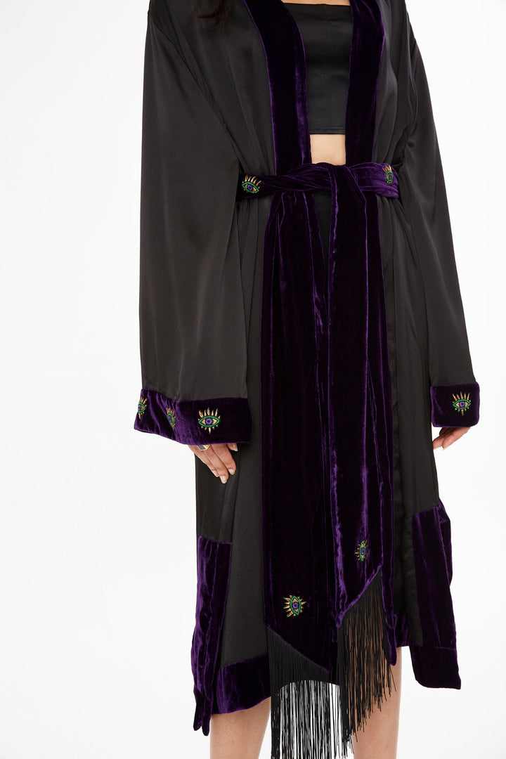 The Midnight Kimono in black silk with purple velvet trim and embroidery, velvet trim and fringe detail, studio