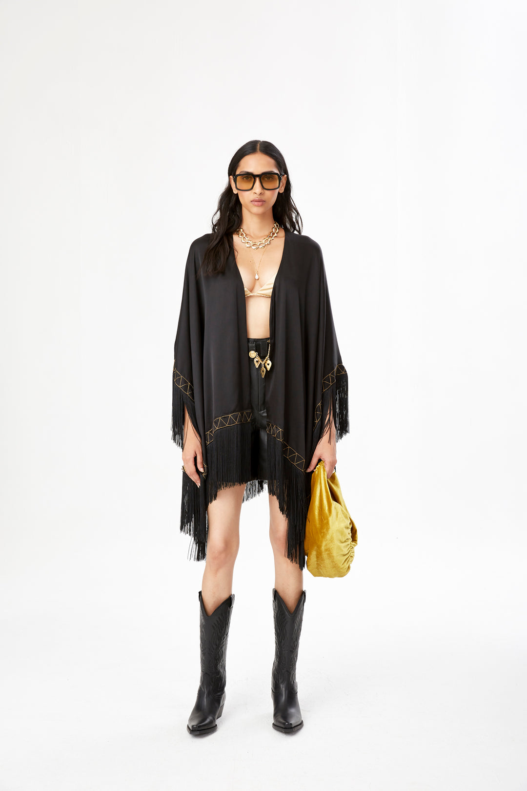 The Nomad Poncho in black silk with gold hand embroidery and black fringe, front view, studio