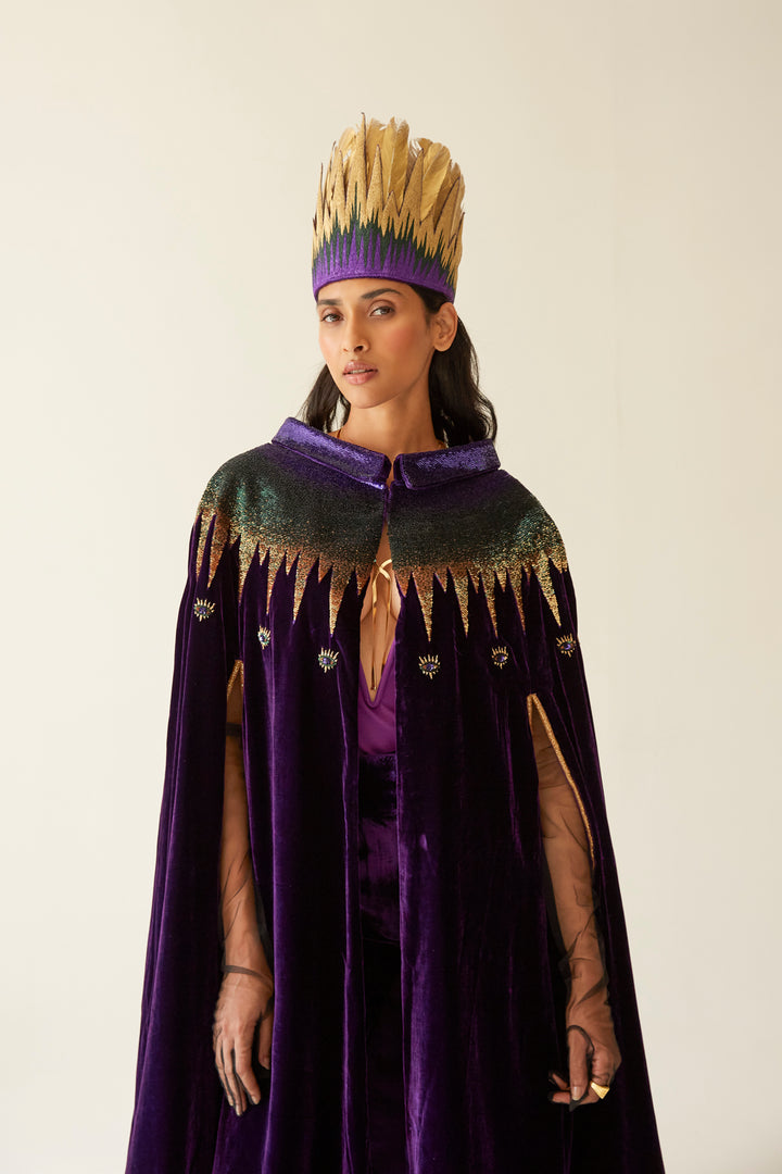 The Rainbow Feather Headdress with golden feathers on a purple band, side view, studio