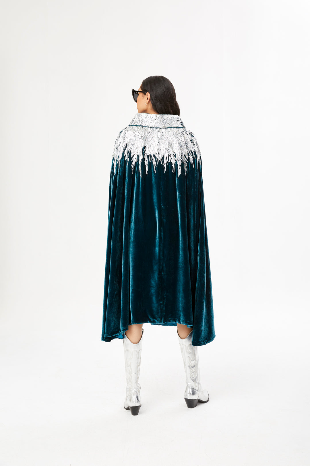 The Silver Feather Cape in petrol silk velvet with silver beaded feathers, back view, studio