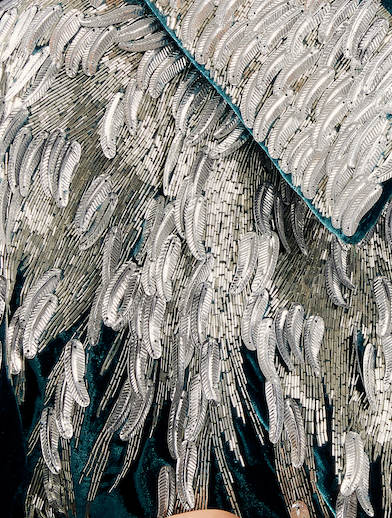 The Silver Feather Cape in petrol silk velvet with silver beaded feathers, beaded feather detail